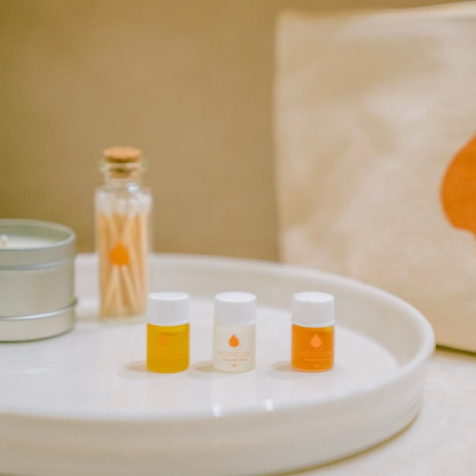 Ritual kit includes an Aromatherapy trio made with organic essential oils, a soy candle, matches in a glass vial and a canvas travel bag with orange leaf silk screened on one side.